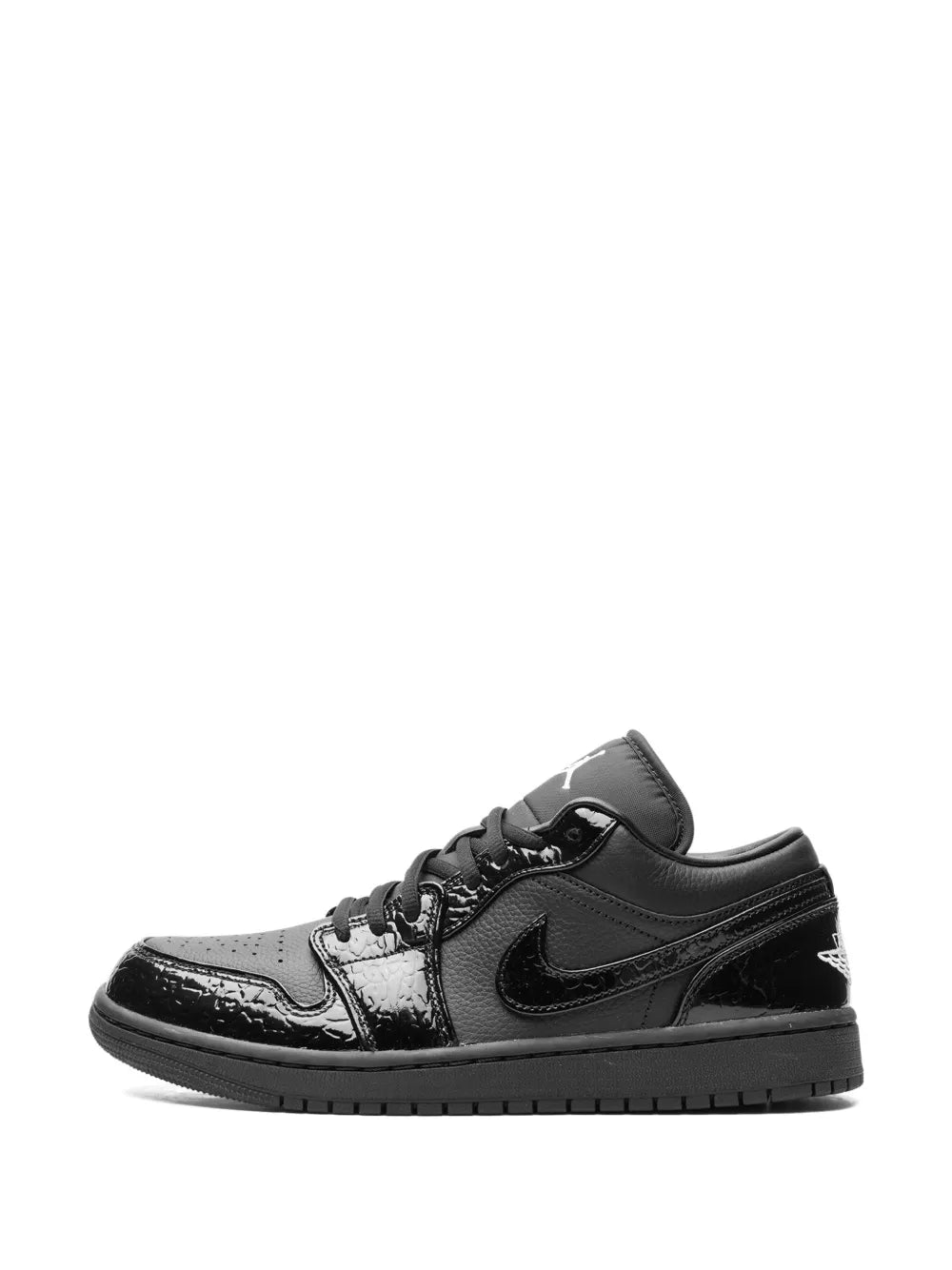 Black lace-up low-top sneaker with swoosh and glossy toe cap