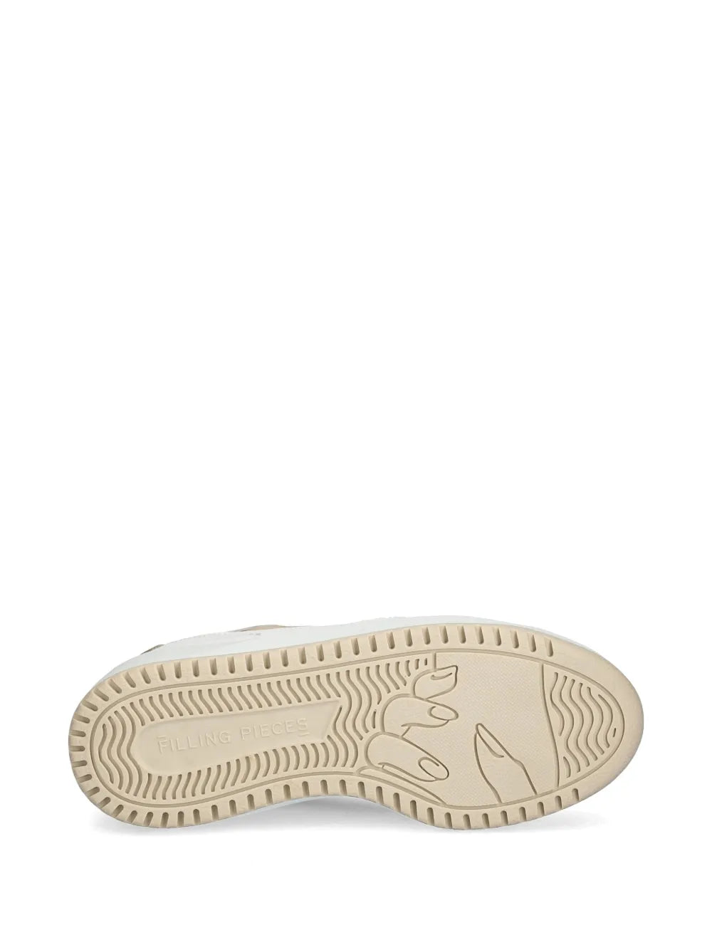 Rubber outsole of white trainers with molded traction tread.