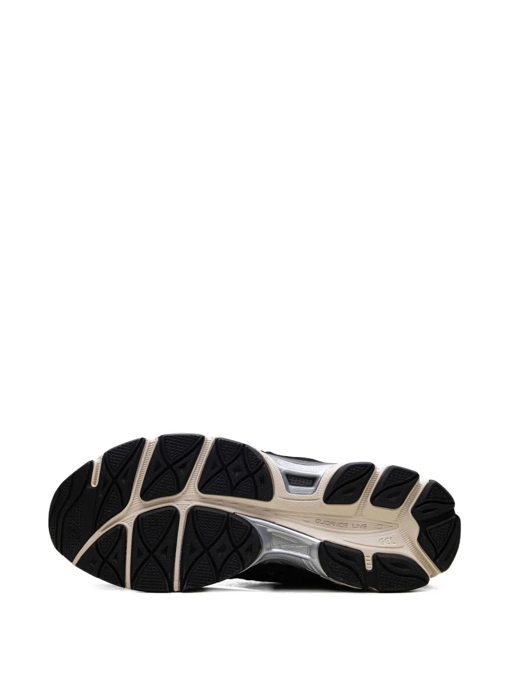 Sole of reddish brown and black lace-up sneakers with treaded rubber outsole