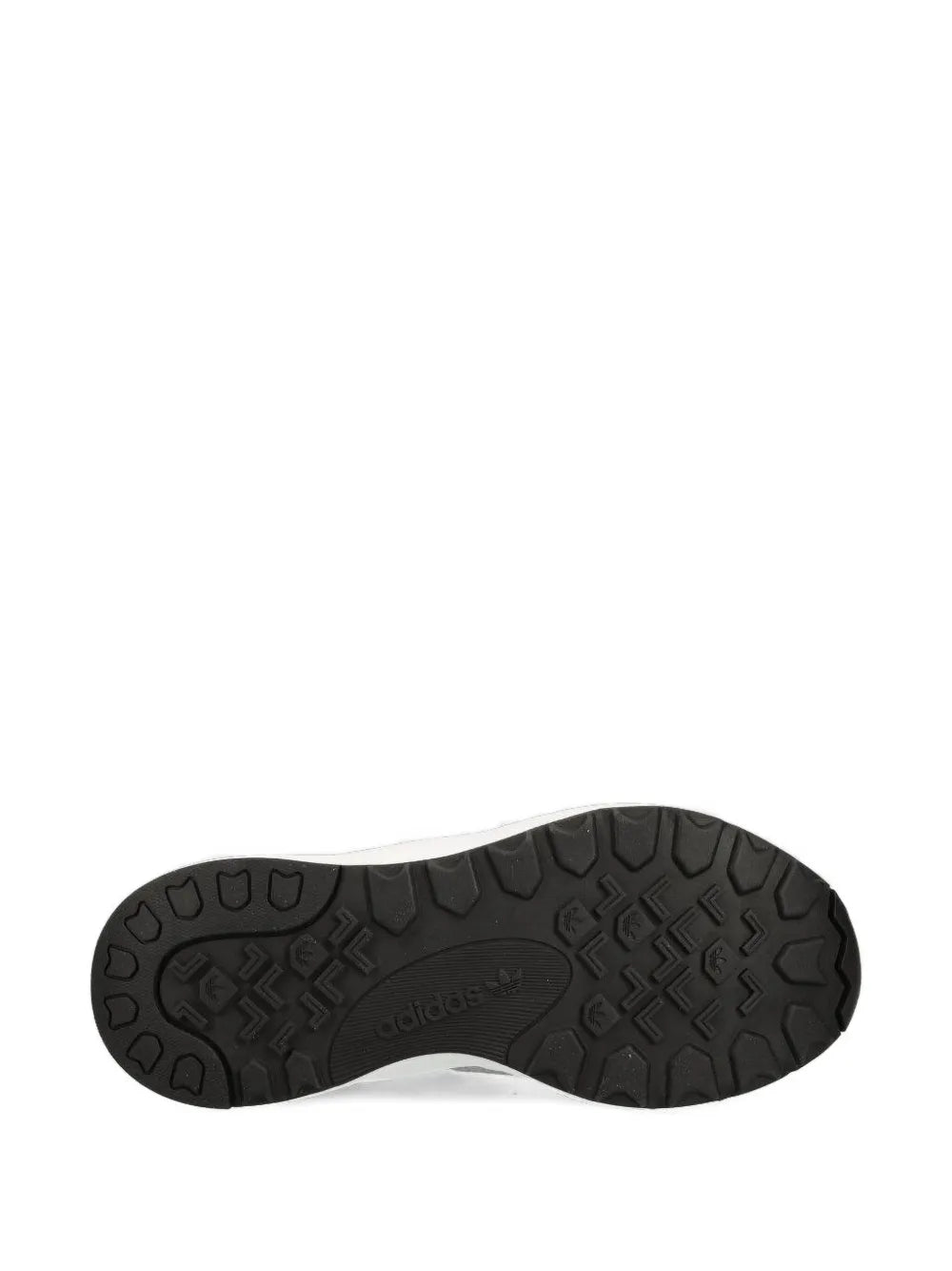 Black rubber sneaker outsole tread with adidas branding at center