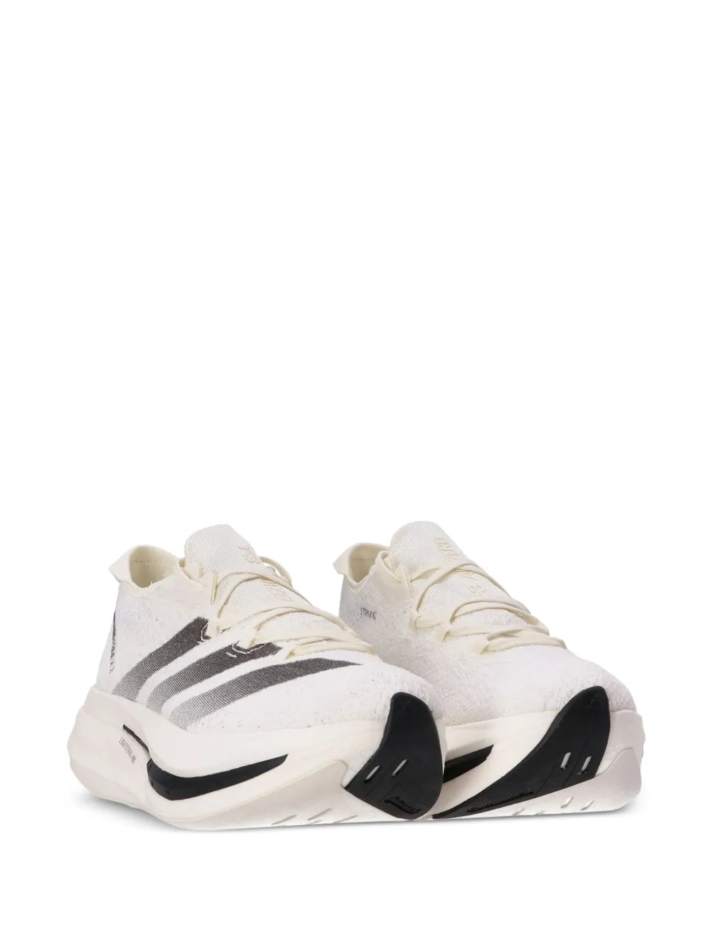 Pair of off-white Strung sneakers with black accents on sides, lace-up