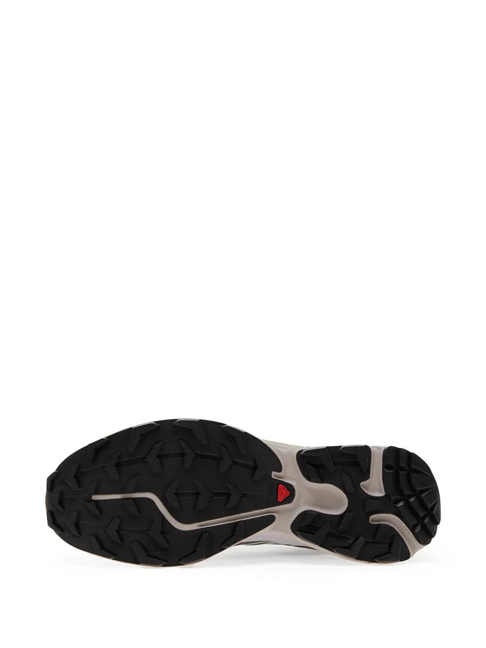 Trail shoe outsole with deep black rubber tread and beige traction segments