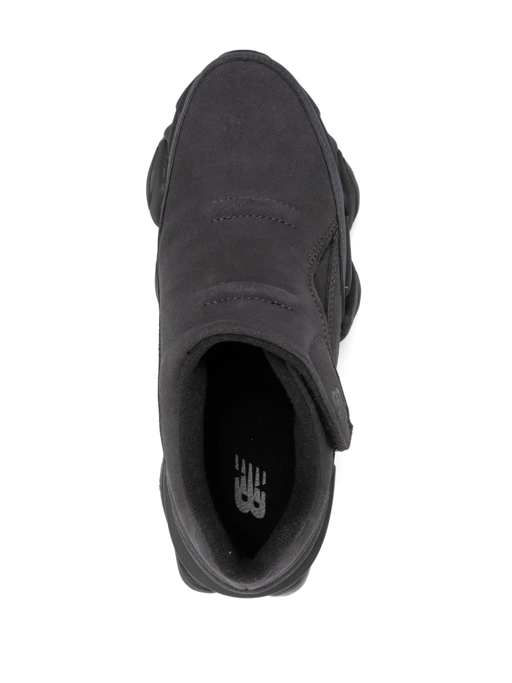 Black sneaker heel and opening with New Balance logo on insole