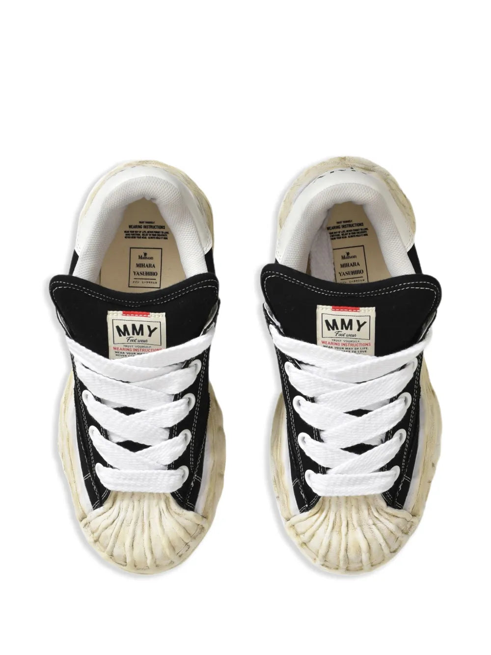 Low-top trainers showing white tongue lining and interior branding labels