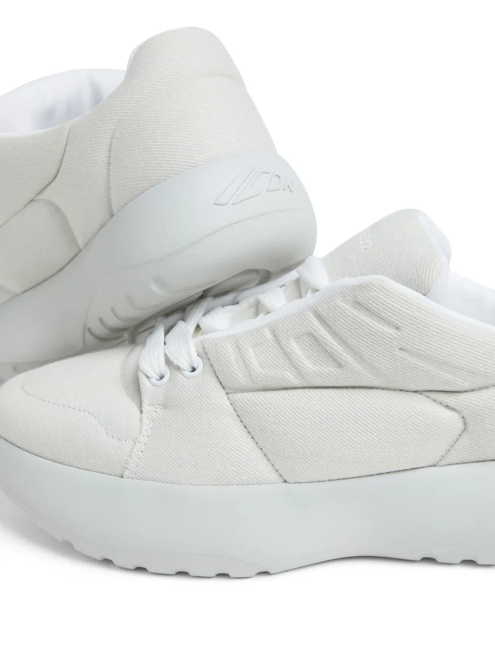 White Dsquared2 sneaker upper close-up with elastic collar and lace panel