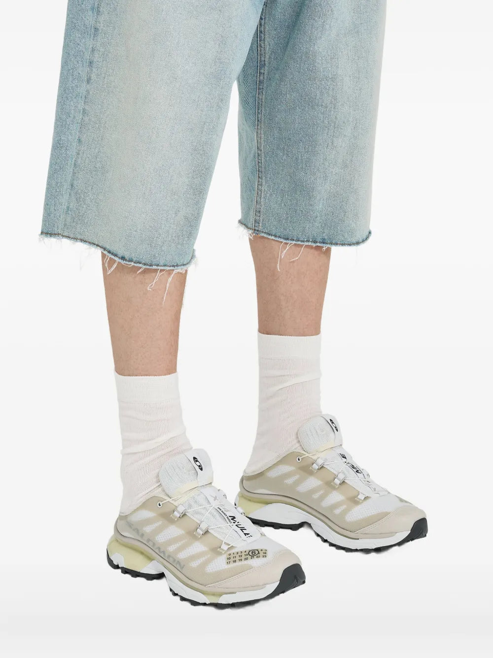 Light beige panelled mule sneakers worn with light denim and white crew socks