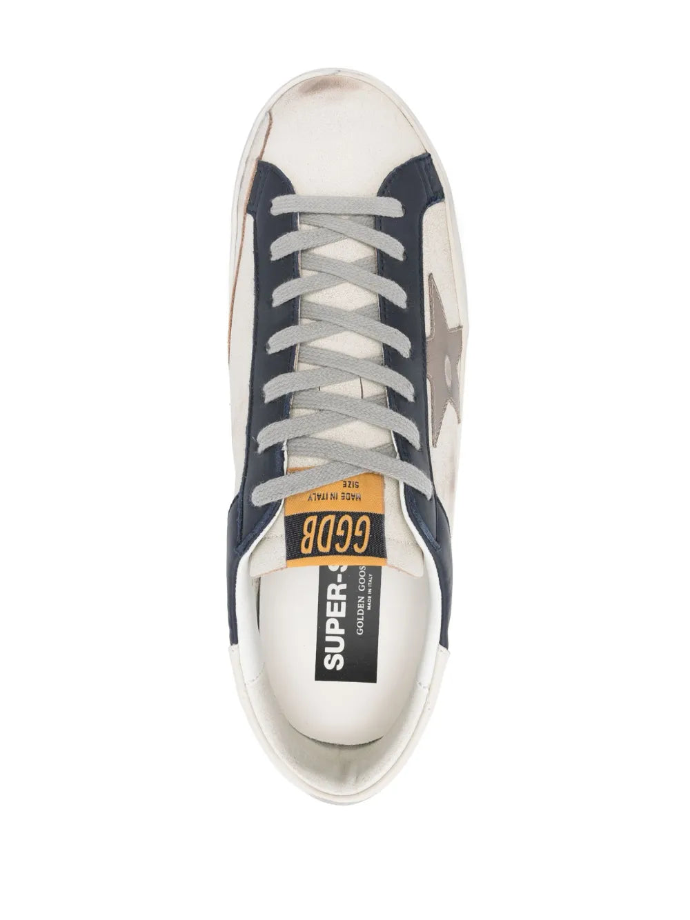 White and navy lace-up sneakers with tongue label and rubber cupsole view