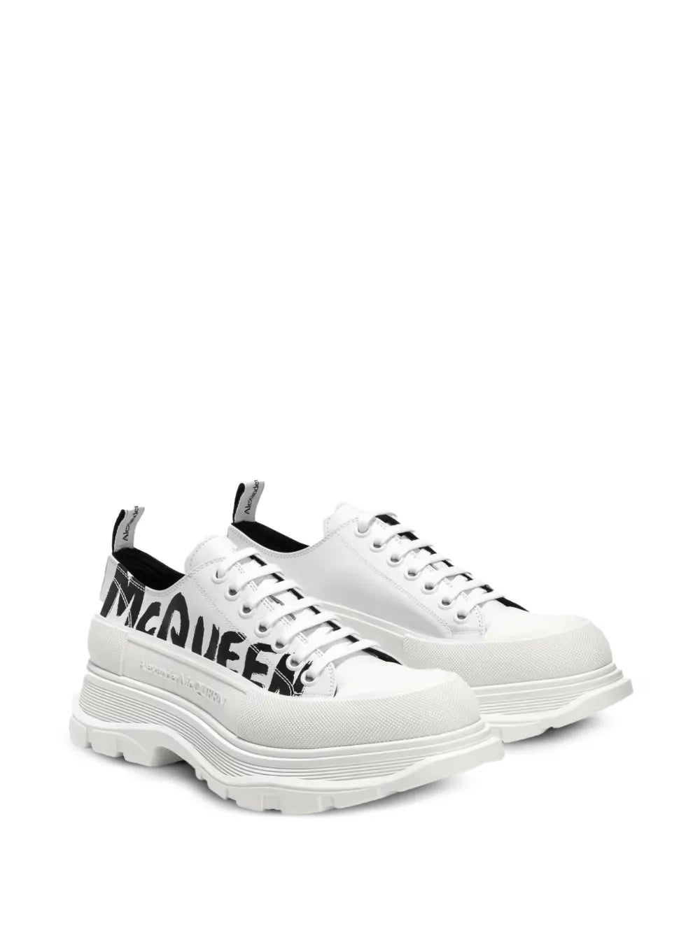 White platform sneakers with lace-up front, chunky tread sole, McQueen side logo