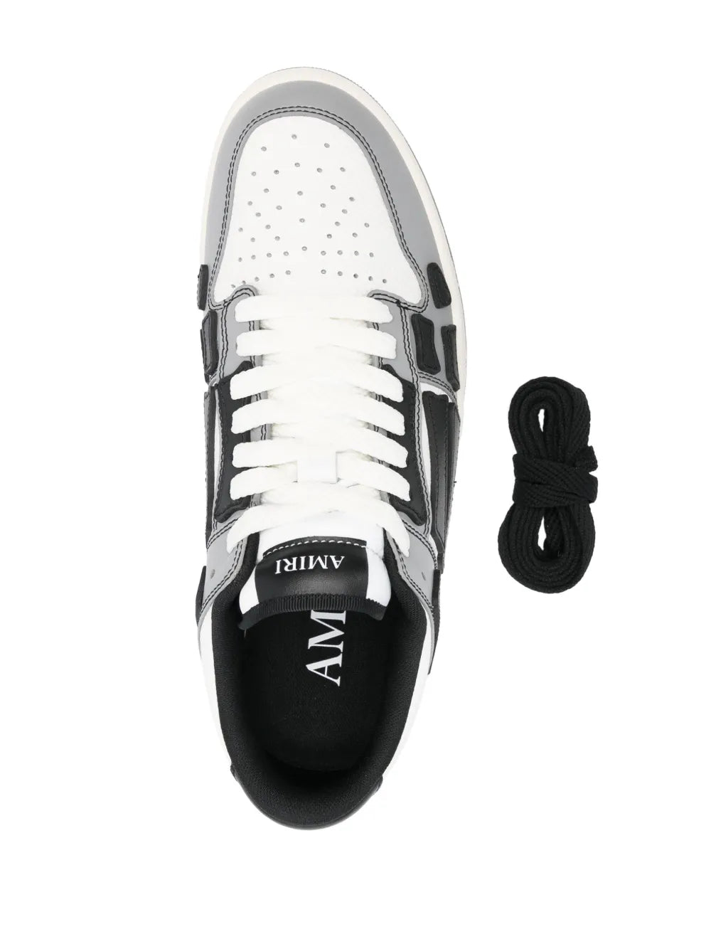 White varsity skel sneakers with black lining, laces and spare set