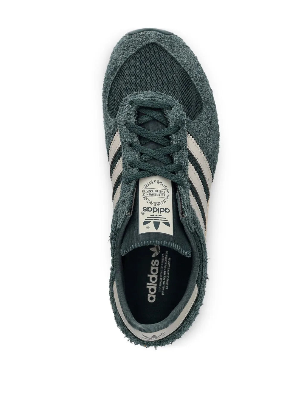 adidas Atlanta sneakers close-up: lace-up dark green with adidas label on tongue