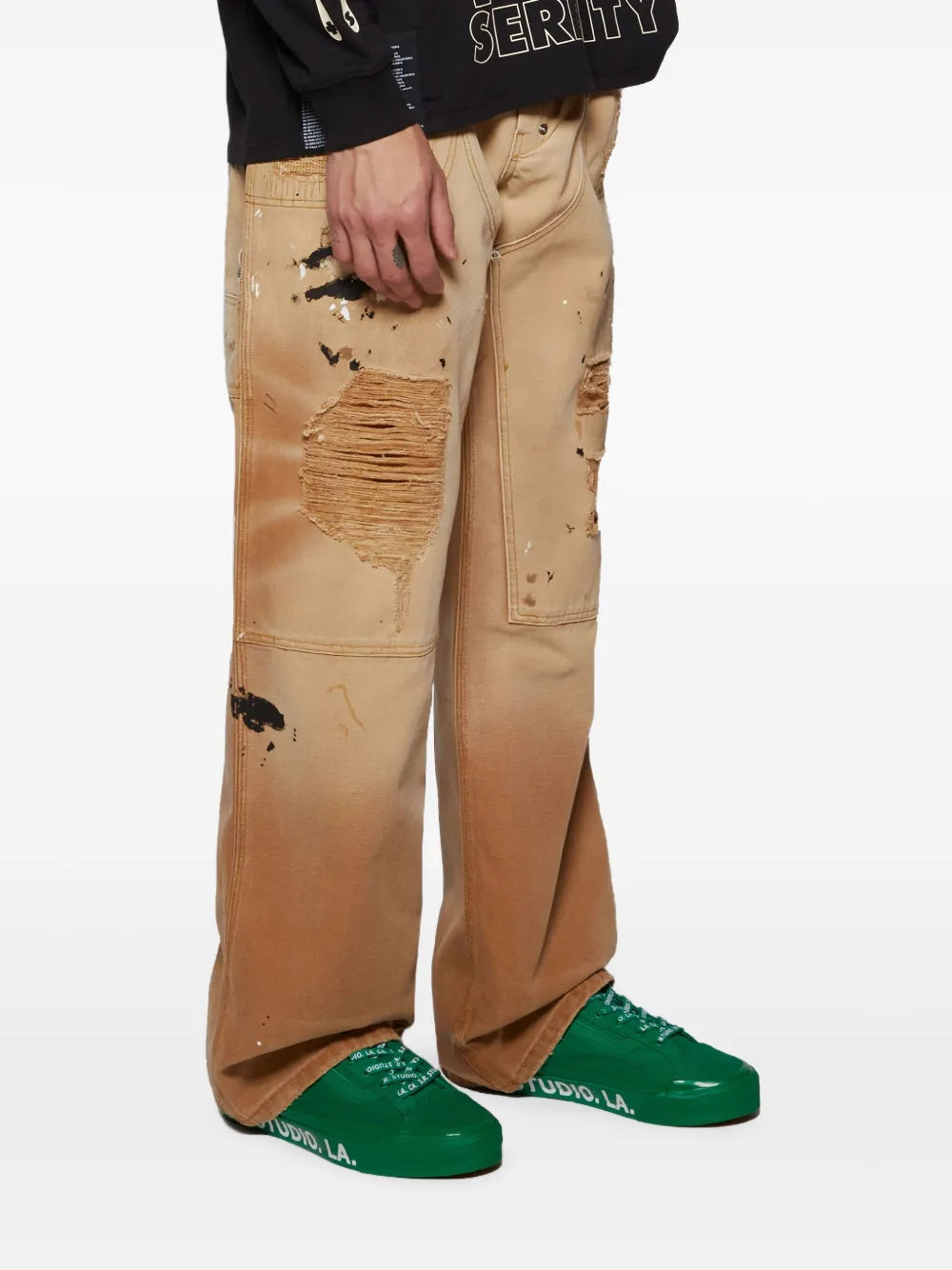 Green low-top sneakers with textured sole, worn with tan distressed jeans