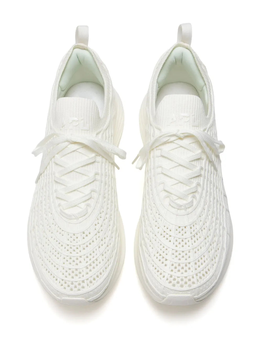 Pair of white lace-up knit sneakers with loop pull tabs