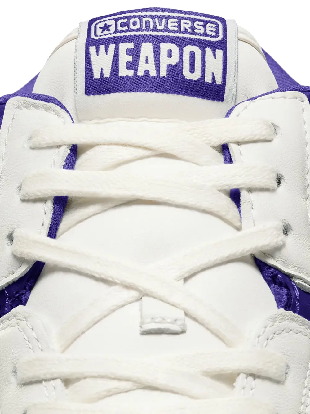 White sneaker upper with purple Converse Weapon heel patch and white lace-up.