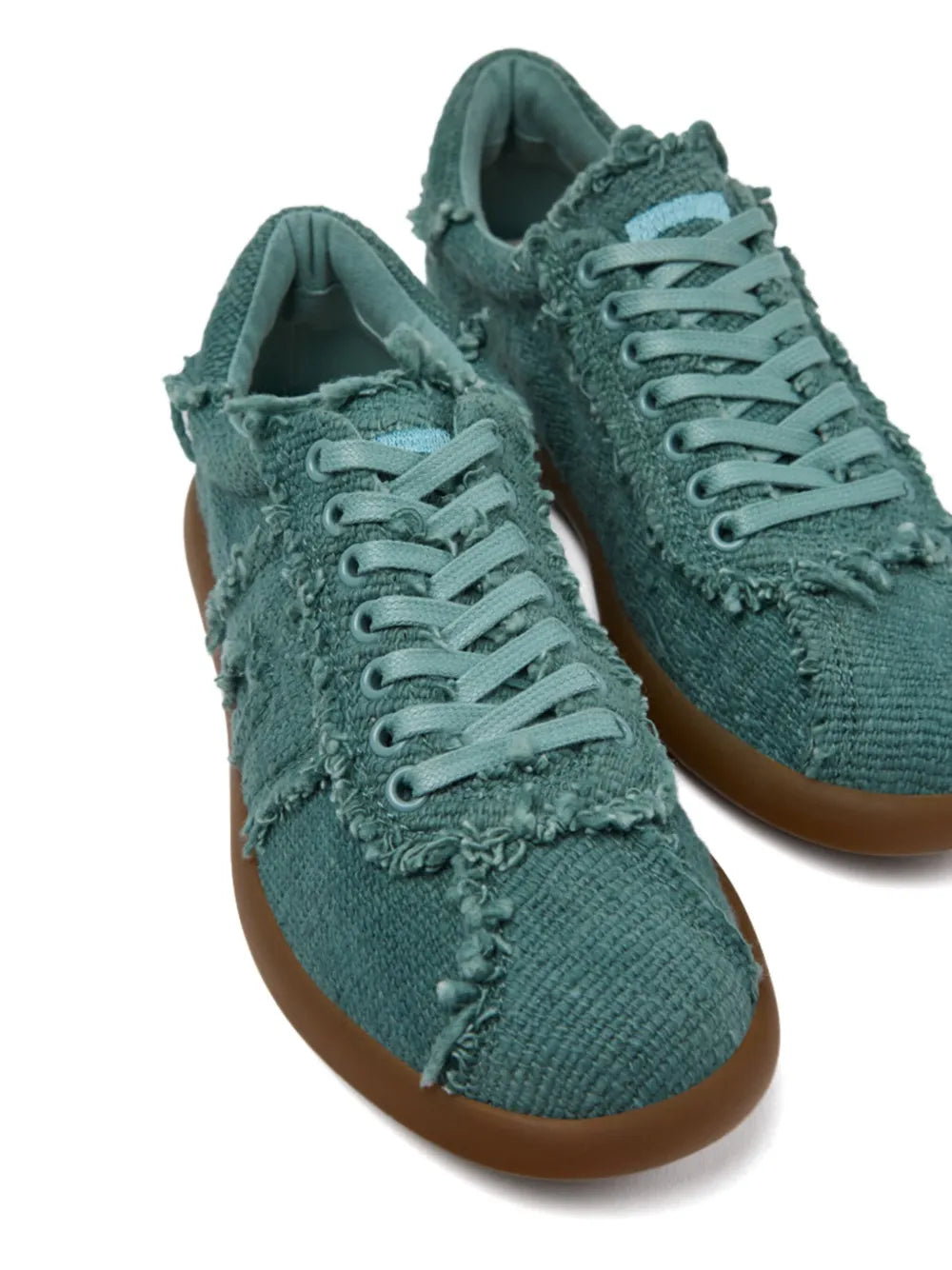 Teal canvas lace-up sneaker pair with frayed seam details and gum soles
