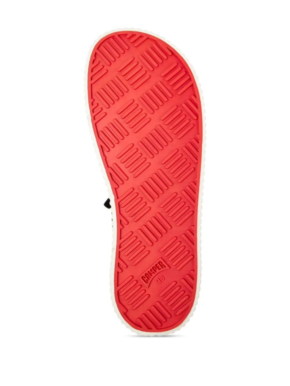 Red rubber outsole with deep tread pattern under sneakers