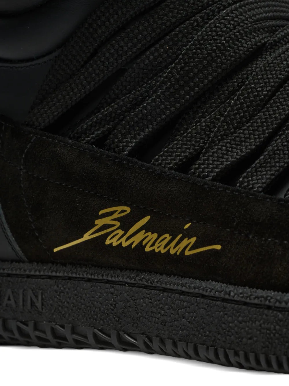 Black leather-panelled Balmain trainers close-up of gold Balmain logo