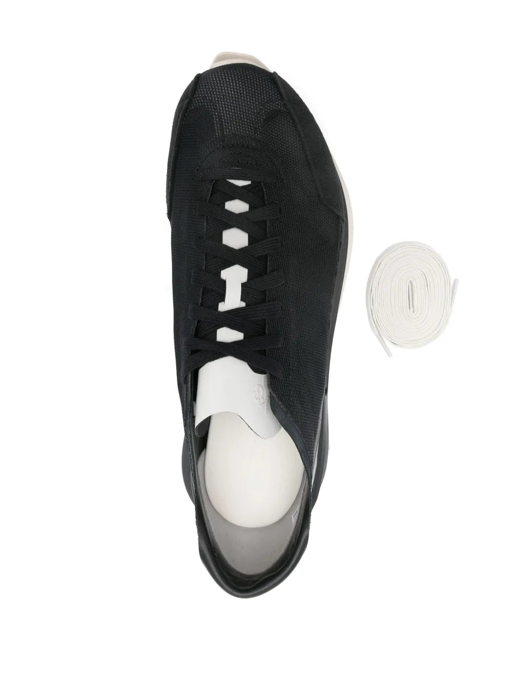 Black lace-up sneaker side view with patterned upper and white insole lining