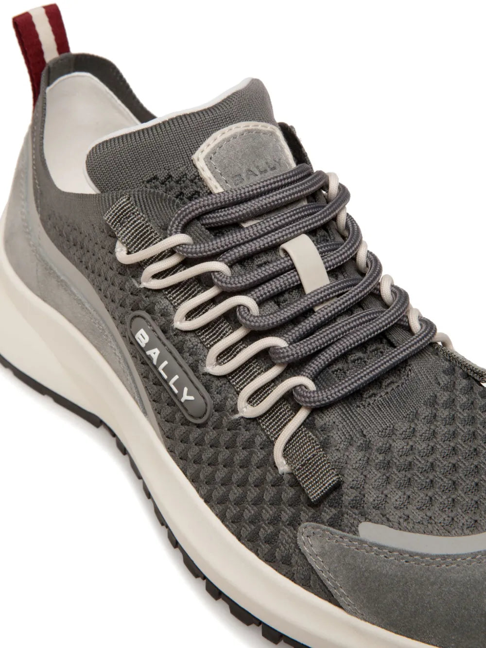 Bally grey trainers close-up with knit upper, lace-up front, and padded collar