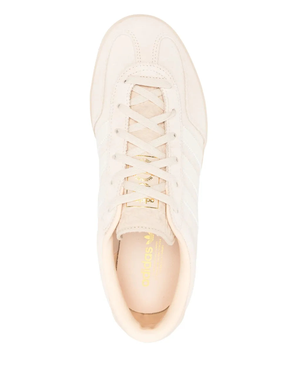 Cream adidas sneakers, lace-up top view, adidas-branded insole and cushioned collar