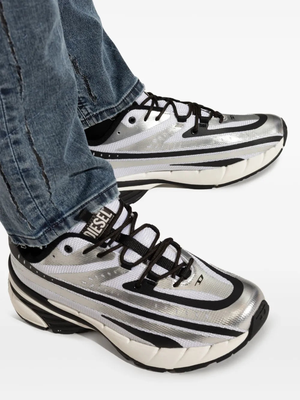 Silver-tone sneakers with black laces and thick striped sole with logo detail
