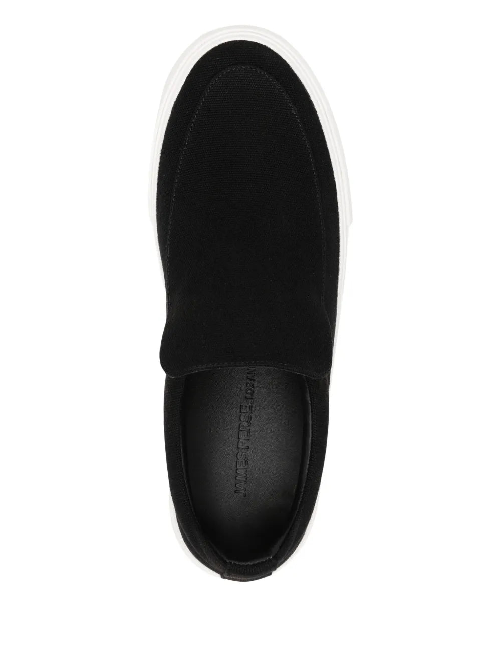 Black canvas slip-on sneaker with dark insole and white stitched edge.
