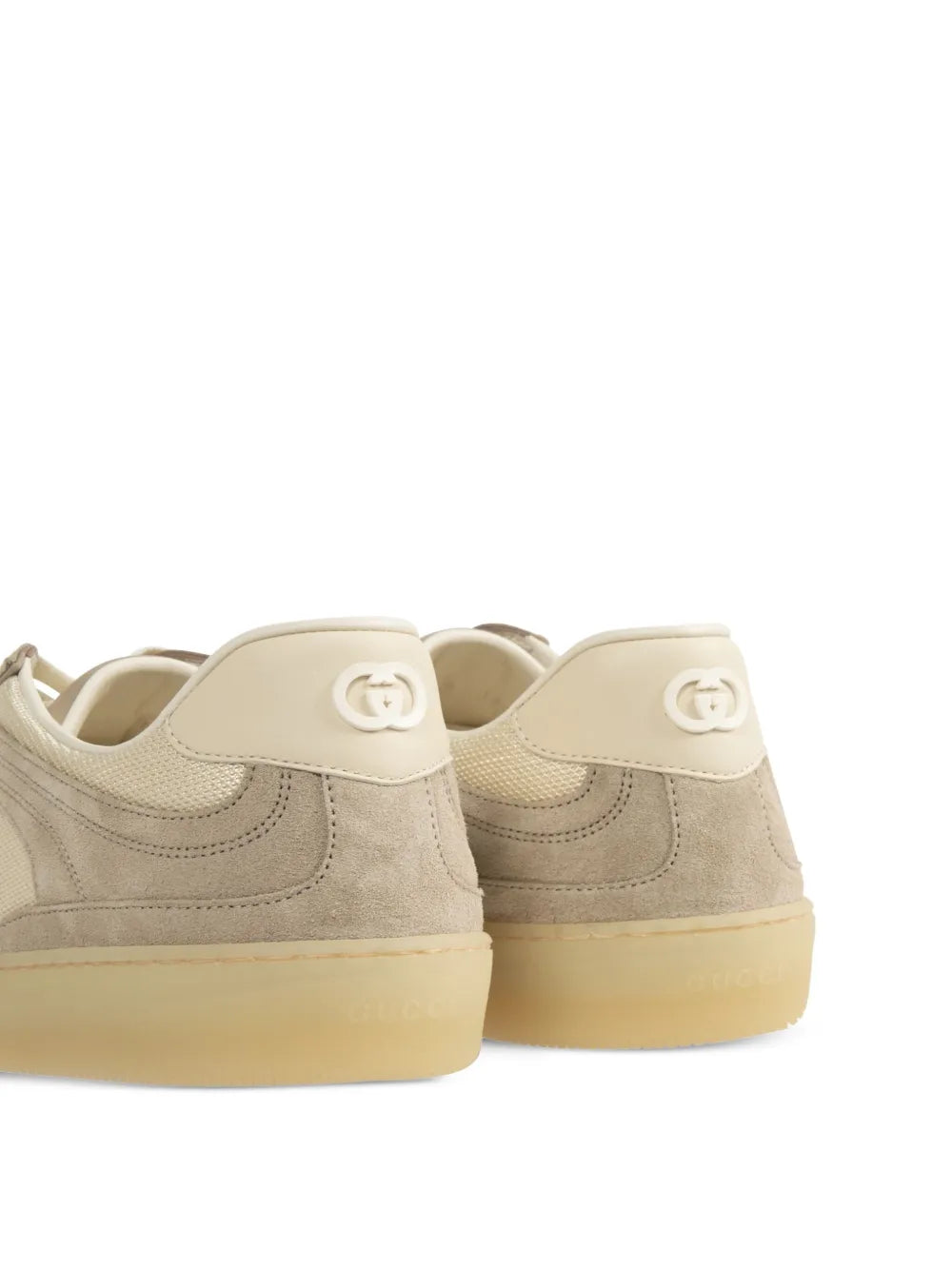 Beige Gucci G74 sneakers rear view with GG logo heel tabs and rubber sole
