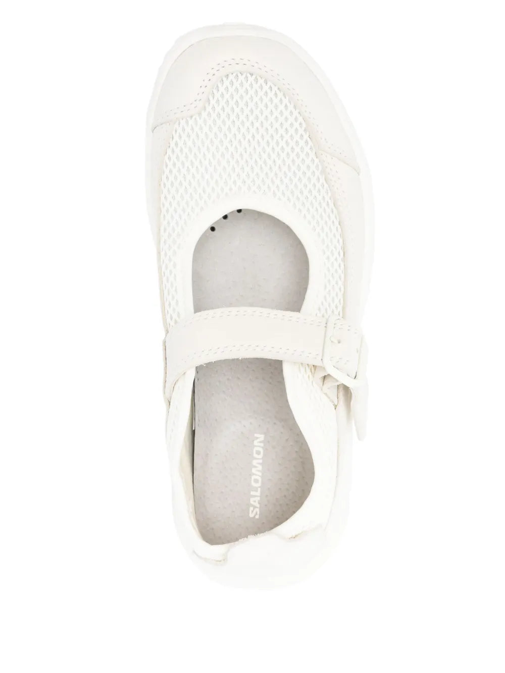 White slip-on sneaker with open toe and strap; logo insole visible