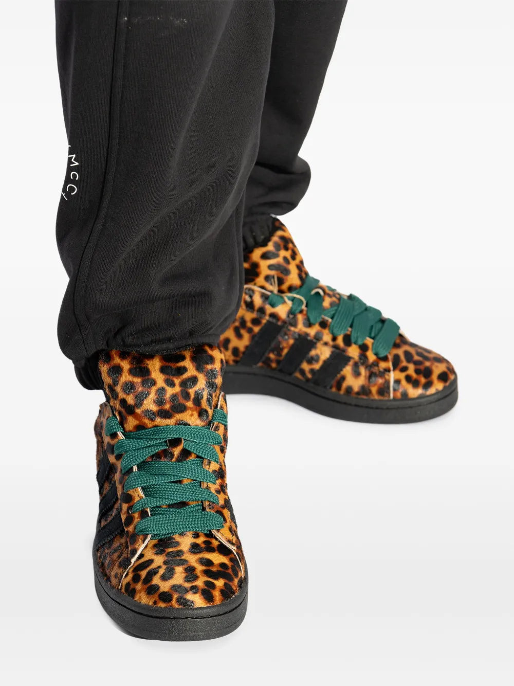 Teal-laced leopard adidas sneakers with black pants cuff