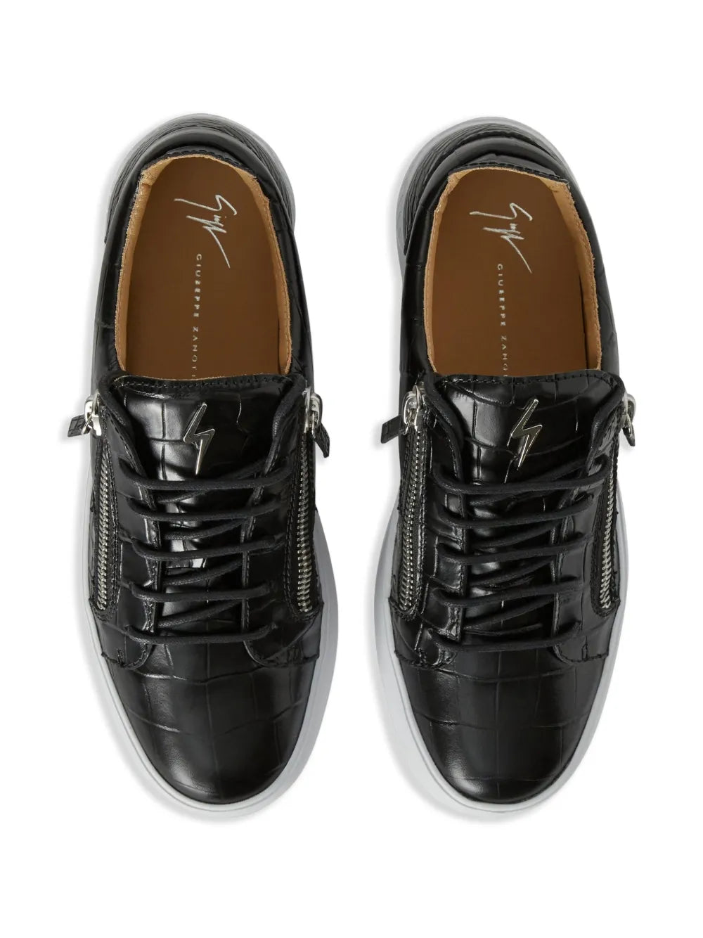 Black low-top lace-up sneakers with side zippers, croc texture, tan lining, white sole.