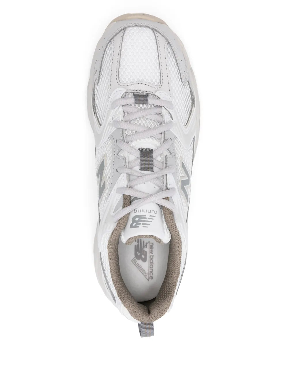 White lace-up sneaker showing tongue tag and cushioned interior