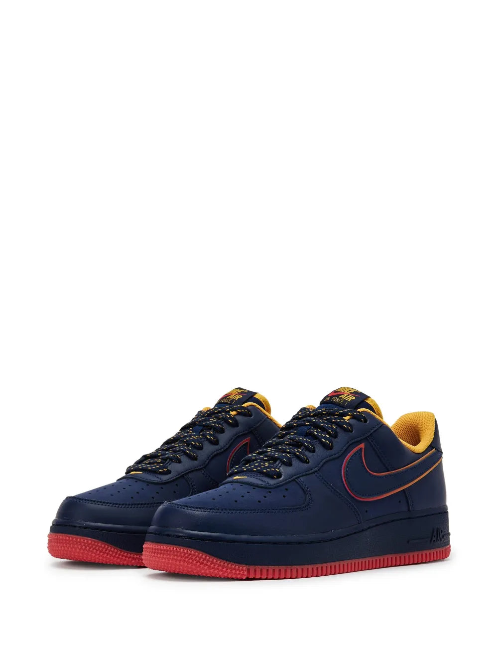 Navy low-top sneaker pair with black laces, red outsole, and yellow inner lining
