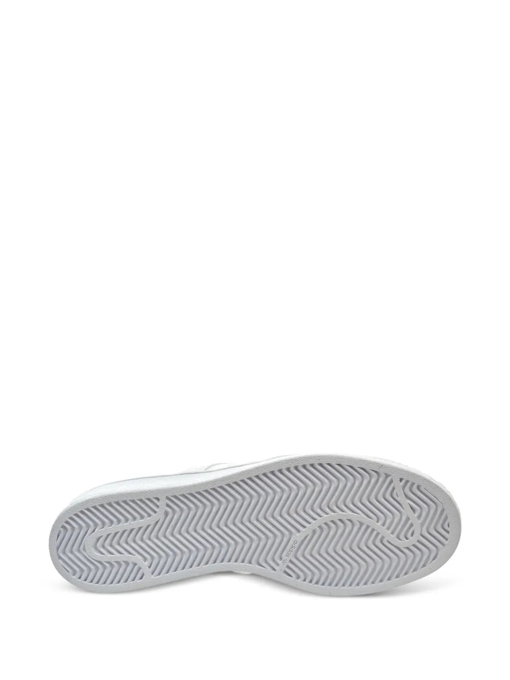 White sneaker outsole with zigzag herringbone tread pattern