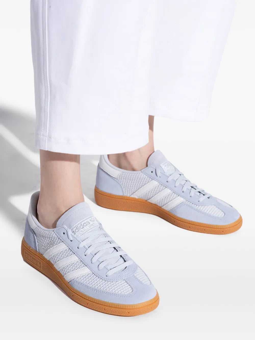 Pair of light blue adidas Spezial sneakers with gum sole and lace-up design
