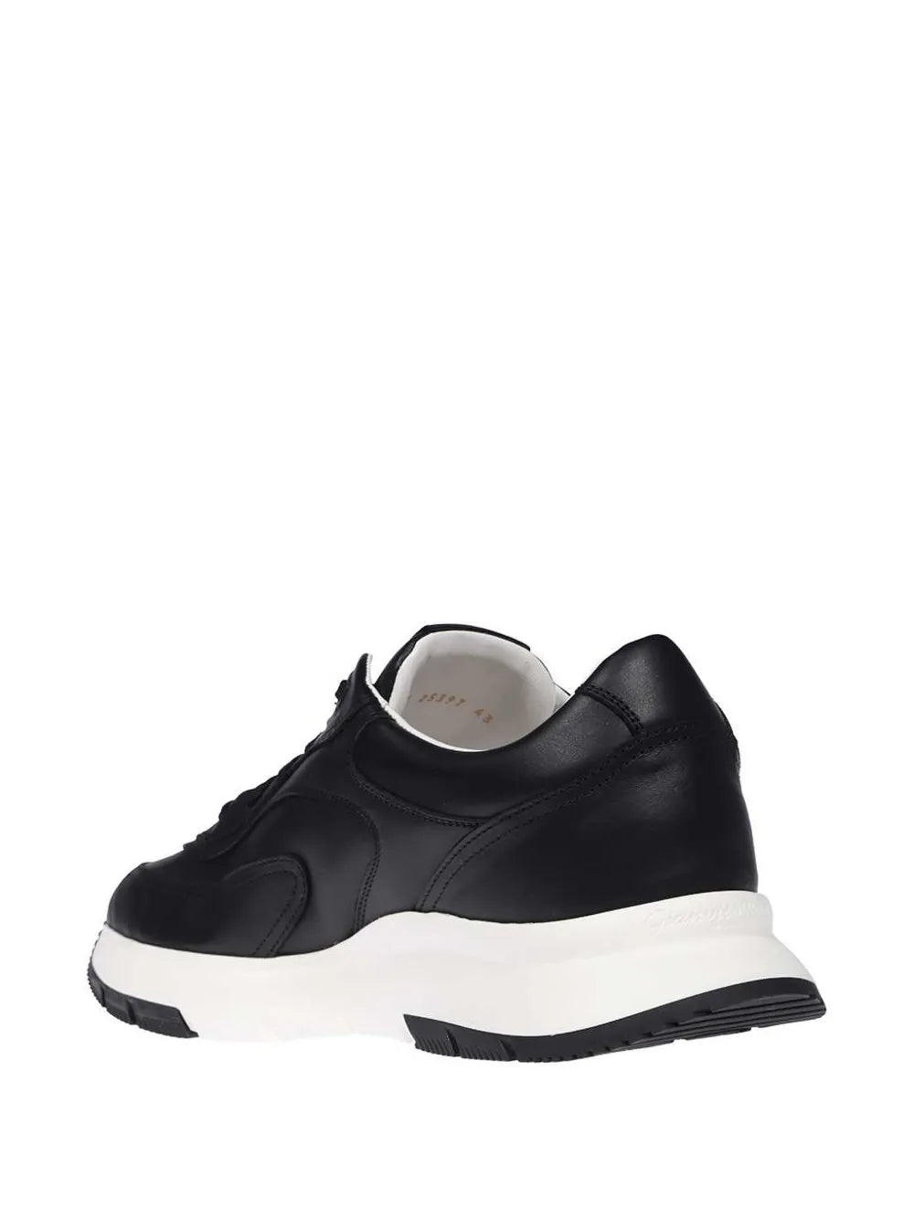 Black leather sneaker heel and back with white sole, padded collar