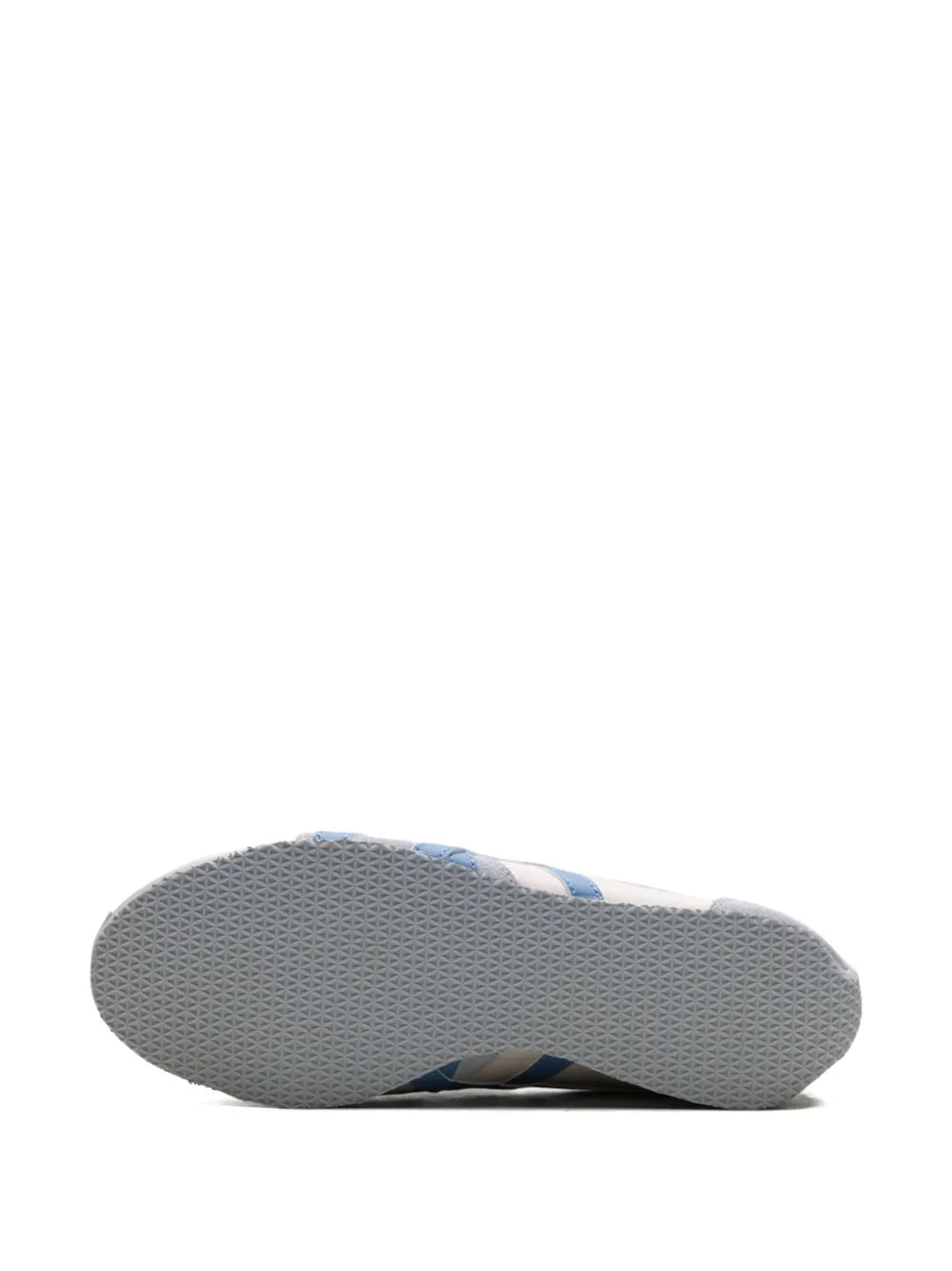 Gray rubber outsole bottom of white sneaker with blue accent