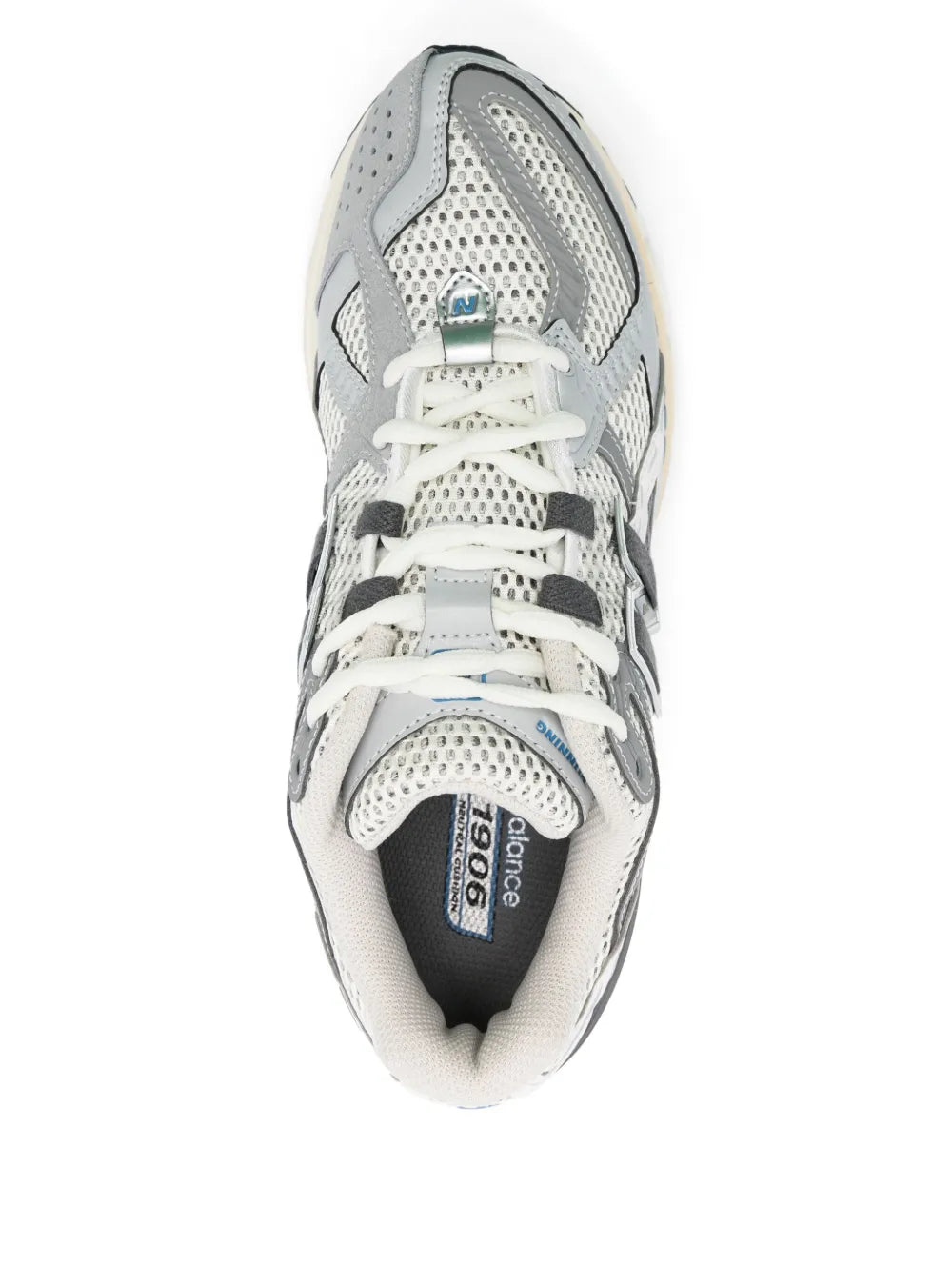 White and grey lace-up sneakers with perforated upper, padded collar, and blue heel tab