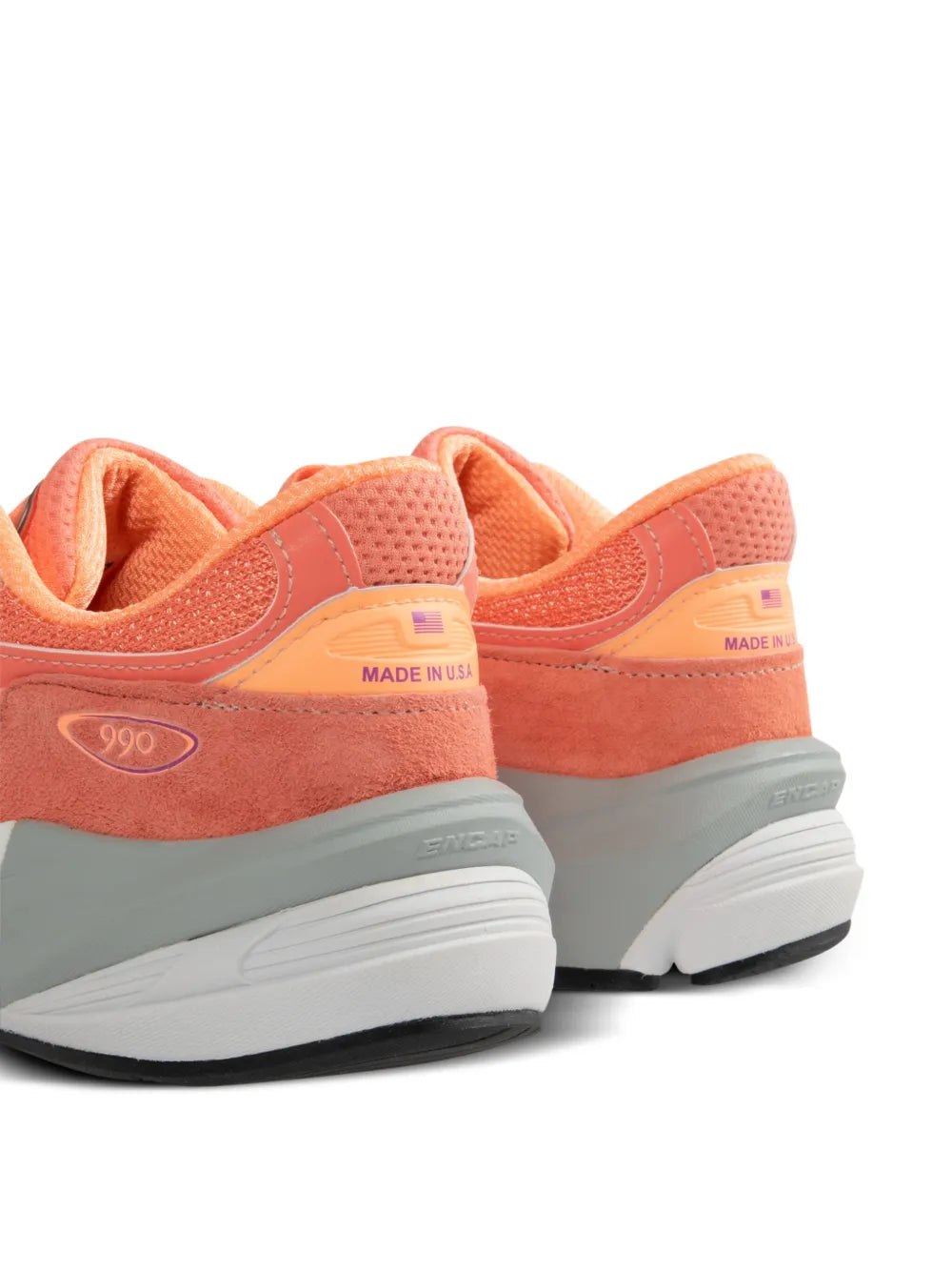 Peach orange New Balance 990V6 sneakers showing heel tabs with "MADE IN USA"