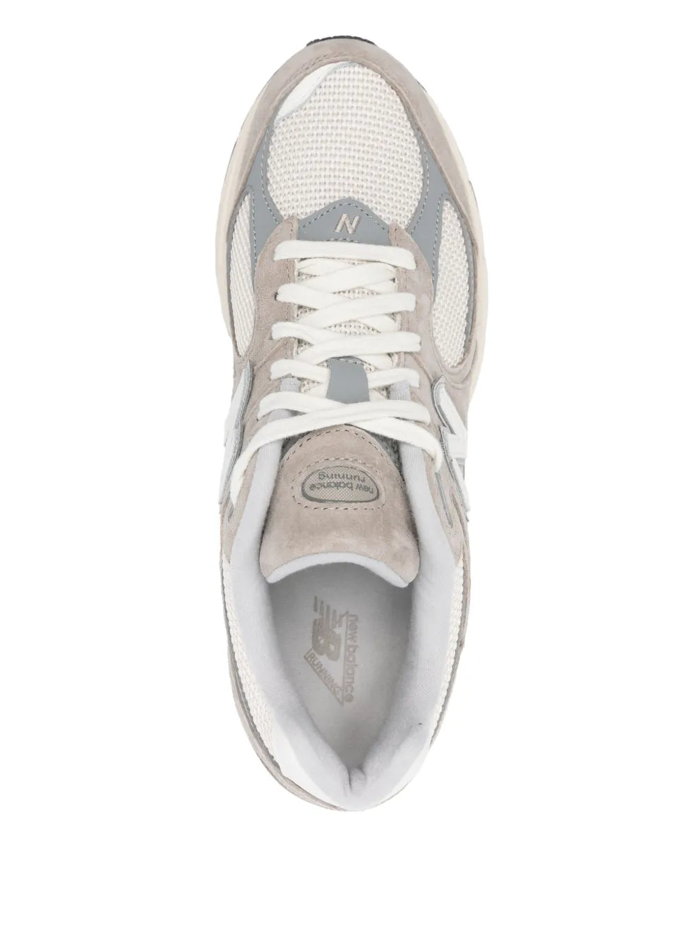Beige New Balance 2002R lace-up sneaker with mesh upper, padded collar, and fabric lining