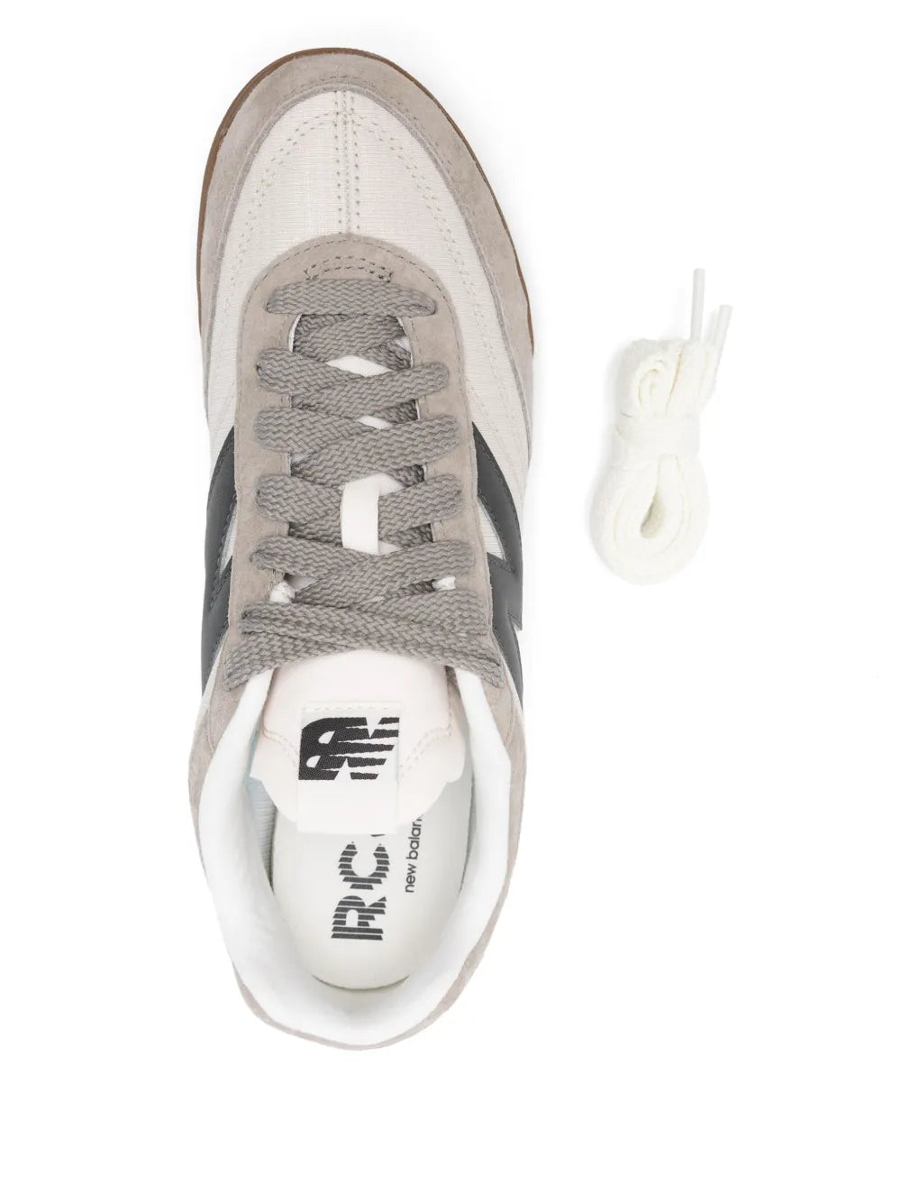 New Balance RC42 sneakers close-up, grey laces, tongue logo, white interior lining.