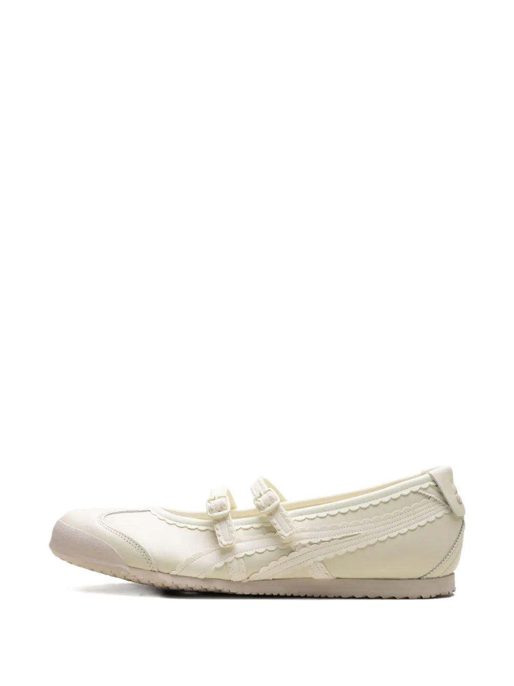 Cream low-top lace-up sneaker with scalloped side stitching and rubber toe cap
