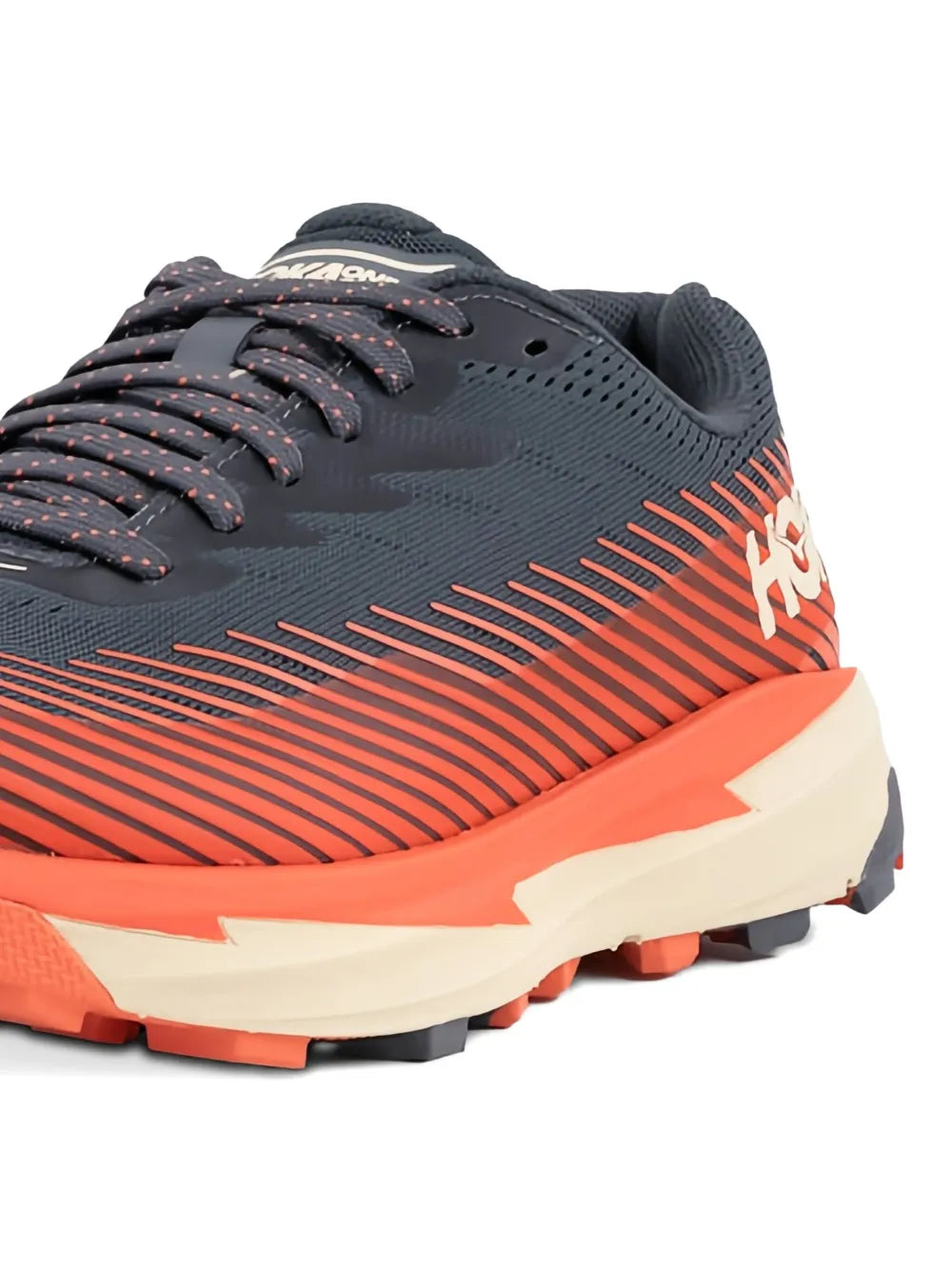 HOKA trail running shoe close-up: dark mesh upper, orange stripes, lace-up