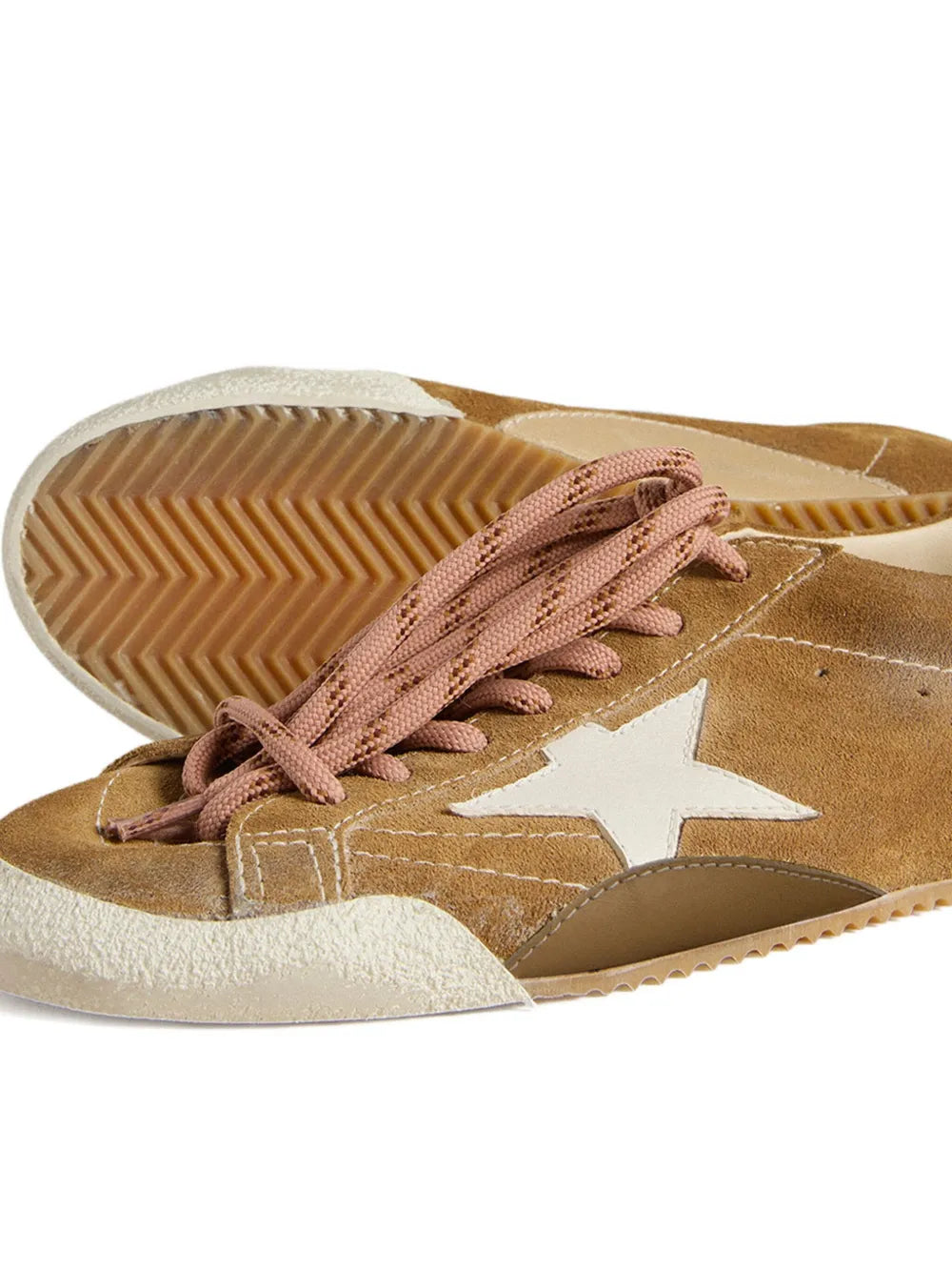 Brown suede sneaker with white star patch, pink laces, and textured rubber outsole
