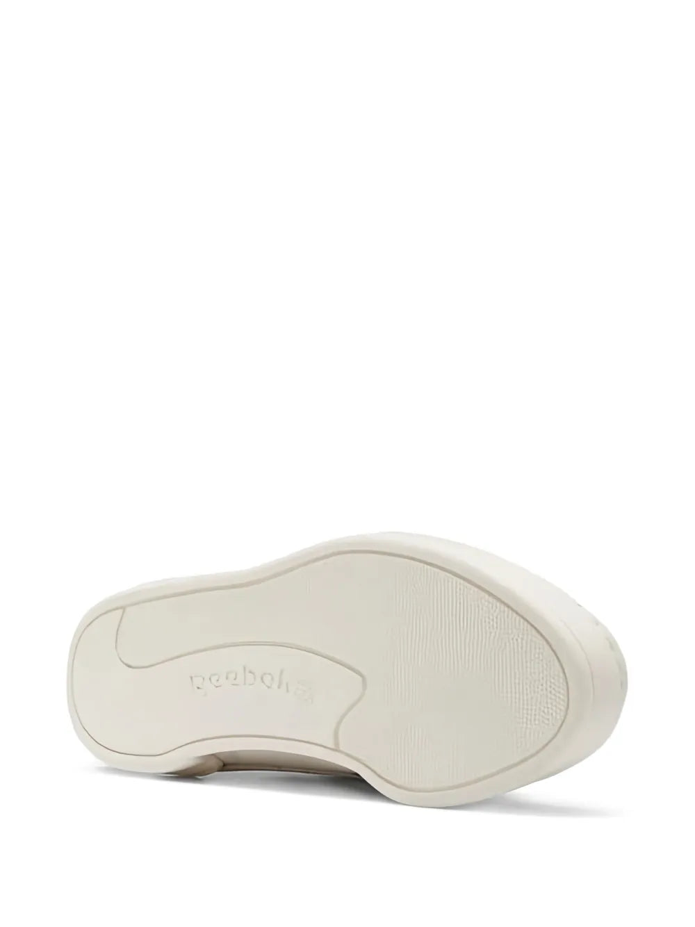 White rubber outsole of high-top sneakers with Reebok branding