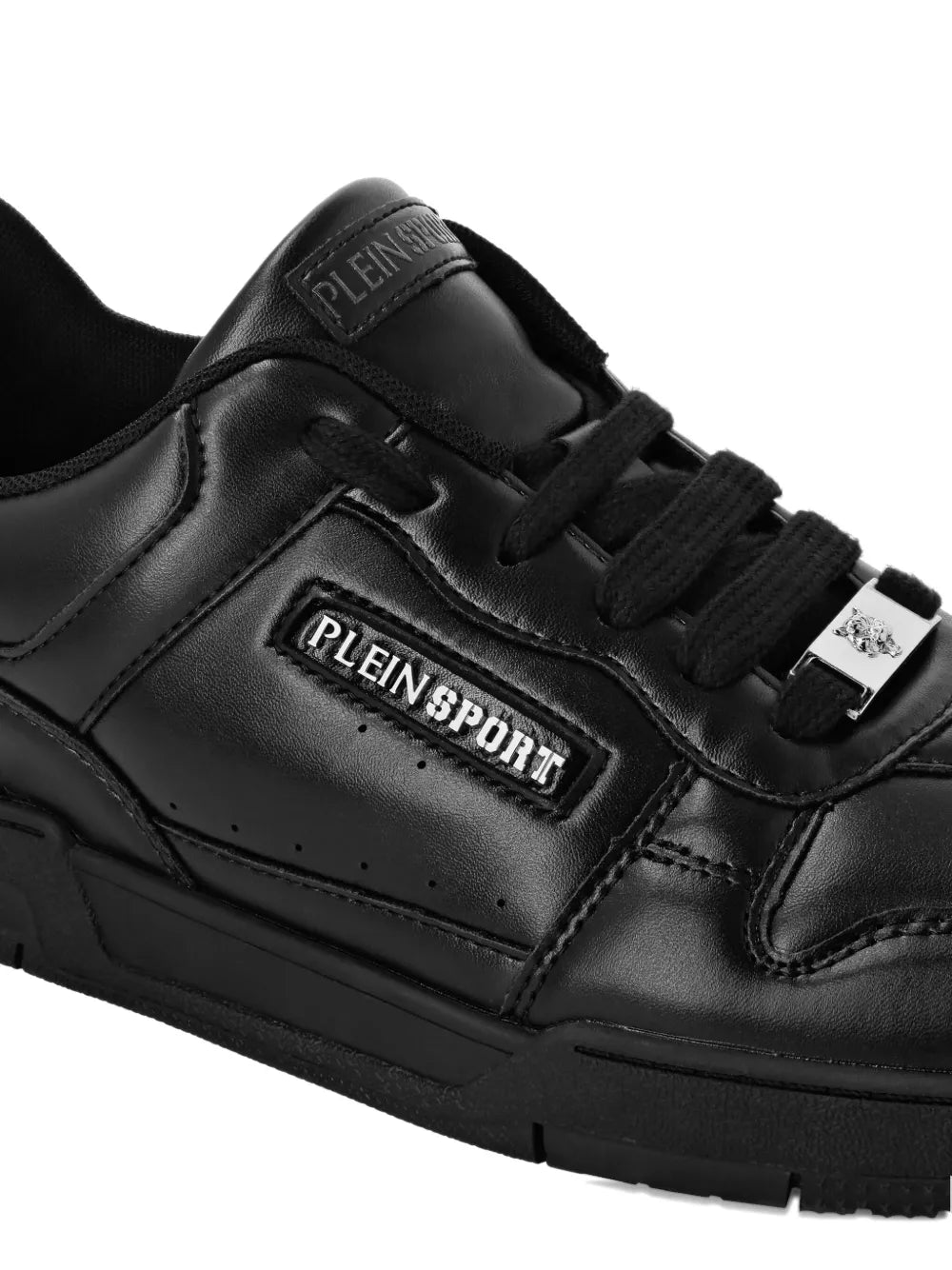 Black leather sneaker close-up with PLEINSPORT logo plaque on the side