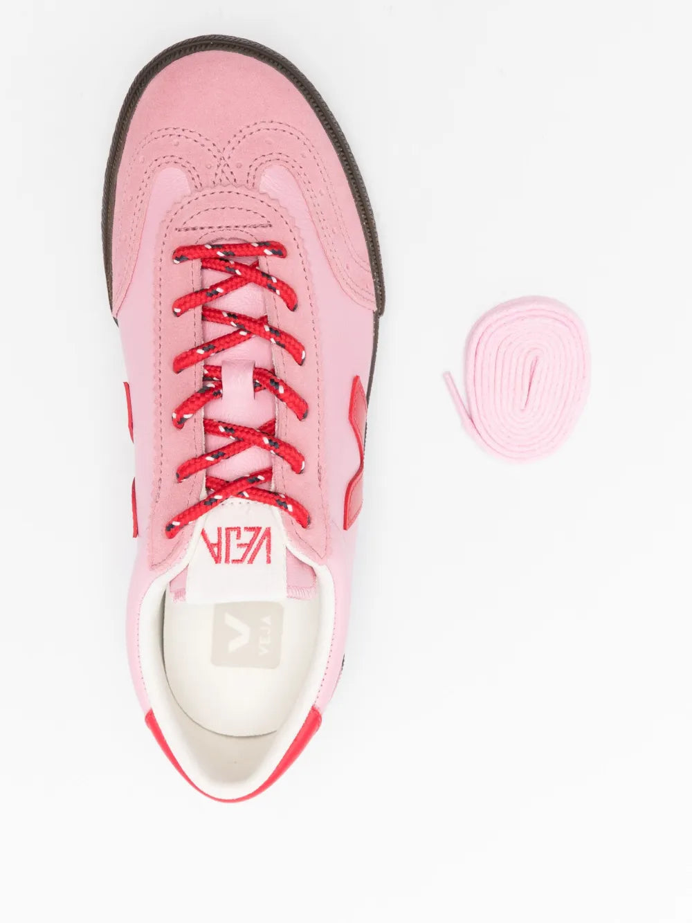 Pink low-top shoe with red laces and stitched toe cap, black sole edge