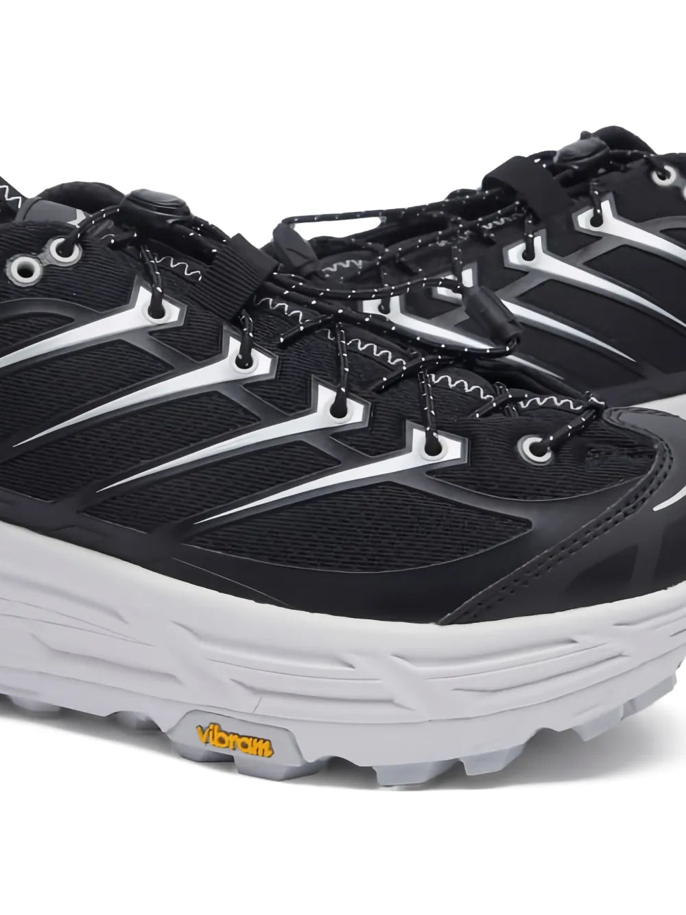 Black Hoka mesh sneakers with lace-up, silver overlays, and Vibram logo on sole