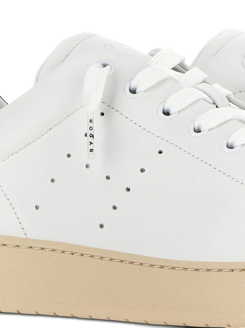 Hogan H672 white sneaker close-up with perforated toe, white laces, beige sole