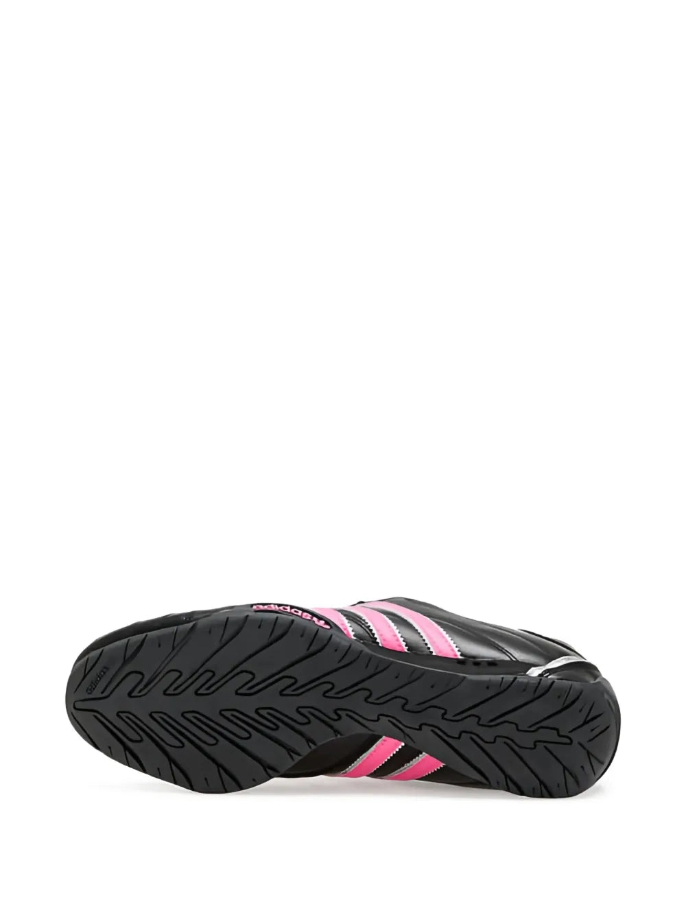 Black rubber outsole of low-top sneakers with pink-striped detailing
