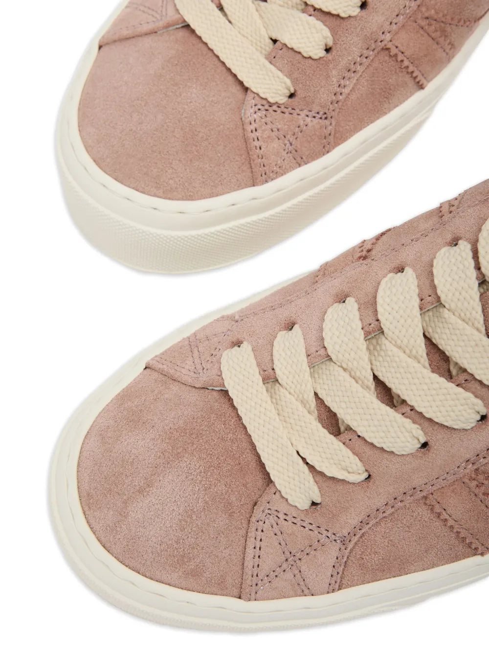 Pink suede low-top sneakers with white laces, textured panels, white sole