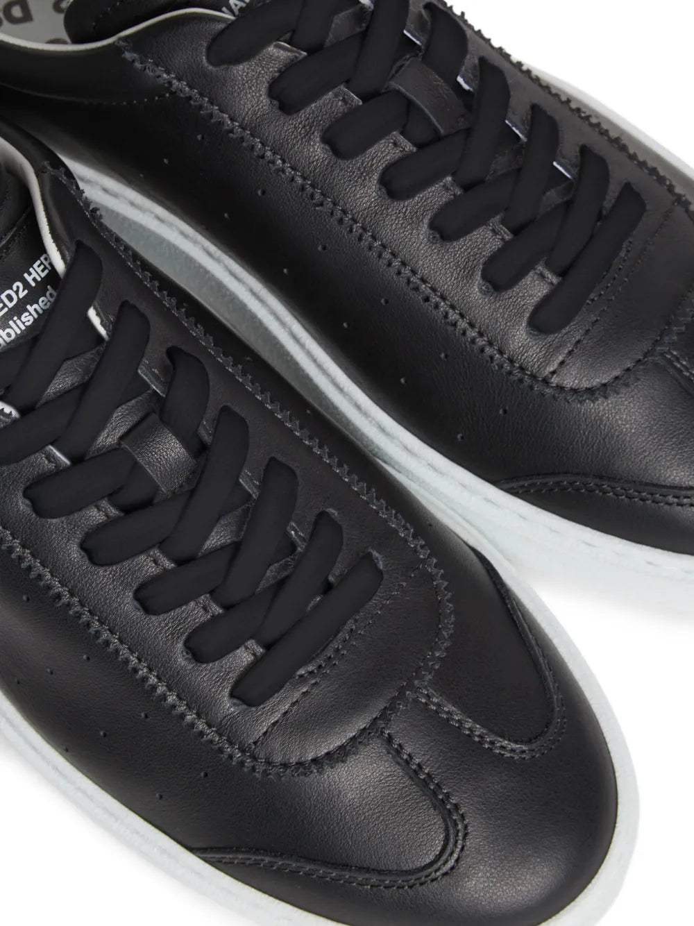 Dsquared2 black leather sneakers close-up, lace panel and stitched swoop, white midsole